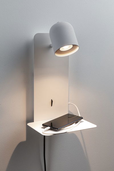 Modern white metal wall spotlight with shelf and smartphone charging cable for LED lighting.