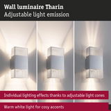Tharin wall luminaire in silver metal with adjustable light cones and warm white lighting accents