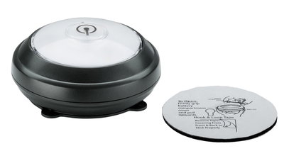 Black LED light with clear cover and adhesive pad with instructions for easy installation