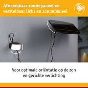 Afneembaar zwart zonnepaneel met verstelbaar licht aan grijze muur voor buitenverlichting