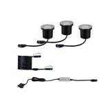 Three black LED ground lights with stainless steel rim, cables and power supply for outdoor lighting.