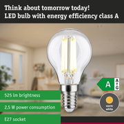 Clear LED bulb with warm white light and ultra-efficient energy use against green forest background