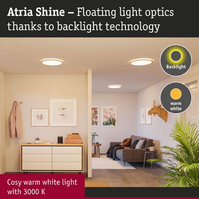 Atria Shine ceiling light with warm white 3000K glow and backlight technology in stylish living room.