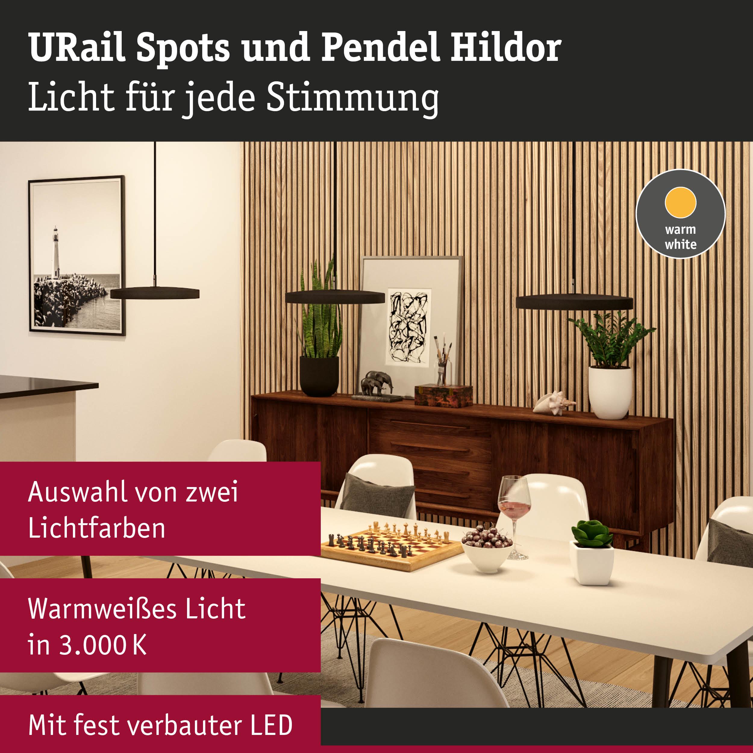 Moderne Pendelleuchten Hildor in Schwarz mit warmweißem LED-Licht über Esstisch mit Schachspiel