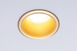 Round recessed LED light with gold reflector and warm white light ideal for living spaces
