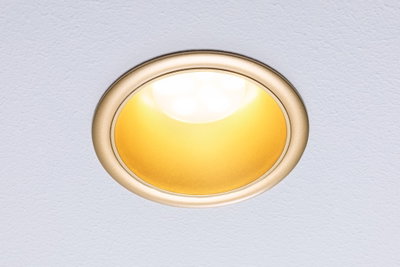 Round recessed LED light with gold reflector and warm white light ideal for living spaces