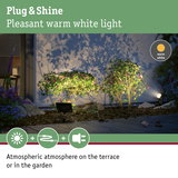 Warm white Plug & Shine LED garden light illuminating plants for atmospheric terrace lighting.