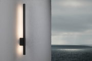 Black metal LED wall light with indirect warm white illumination for modern outdoor spaces.