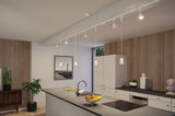Modern white kitchen island with black countertop and white pendant lights on track lighting system.