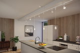 Modern white kitchen island with black countertop and white pendant lights on track lighting system.