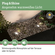 Außenbeleuchtung mit warmweißem Licht auf Kies und Pflanzen für Terrasse und Garten