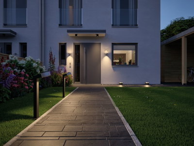 Modern outdoor path with black LED pathway lights and warm white house facade lighting
