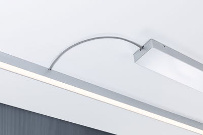 Modern LED ceiling light with silver aluminum housing and flexible connection cable for living spaces.