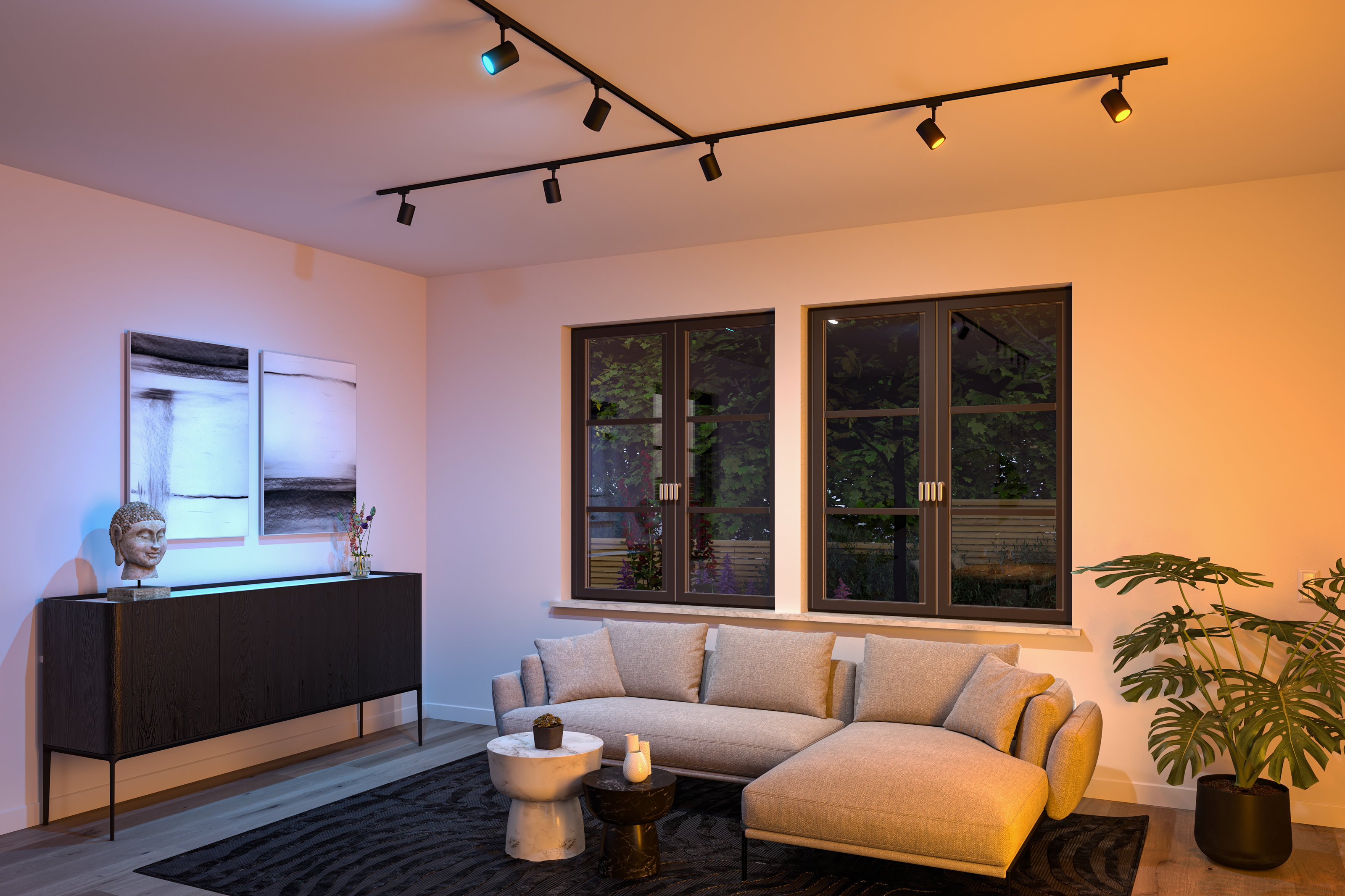 Black LED track lighting with adjustable spotlights in modern living room featuring grey sofa and art.