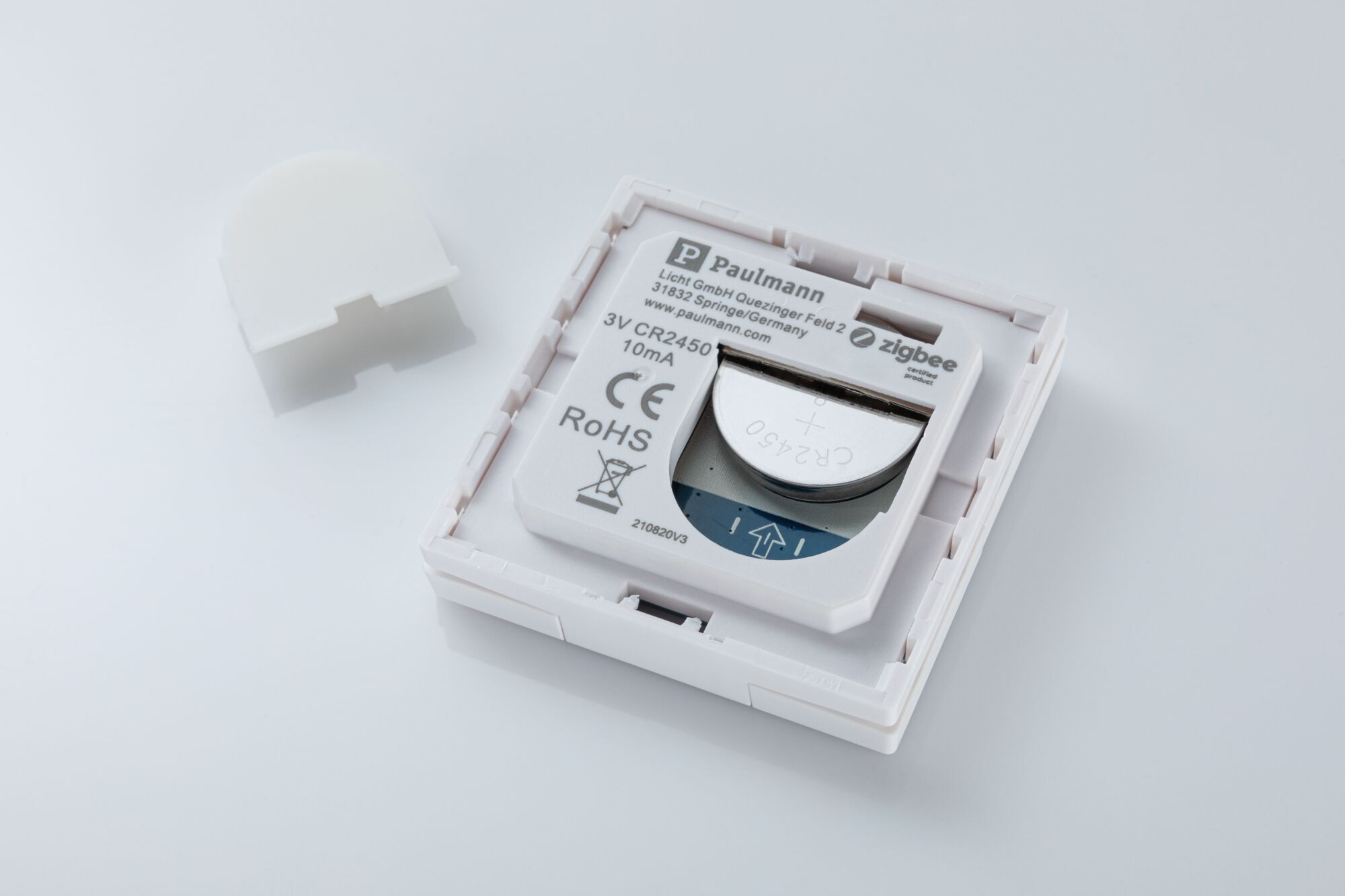 White Paulmann Zigbee battery compartment with CR2450 coin cell for smart lighting systems