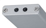 Close-up of silver metal housing with two black sensors and screws for lighting technology