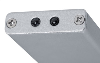 Close-up of silver metal casing with two black sensors and screws for electronic device components