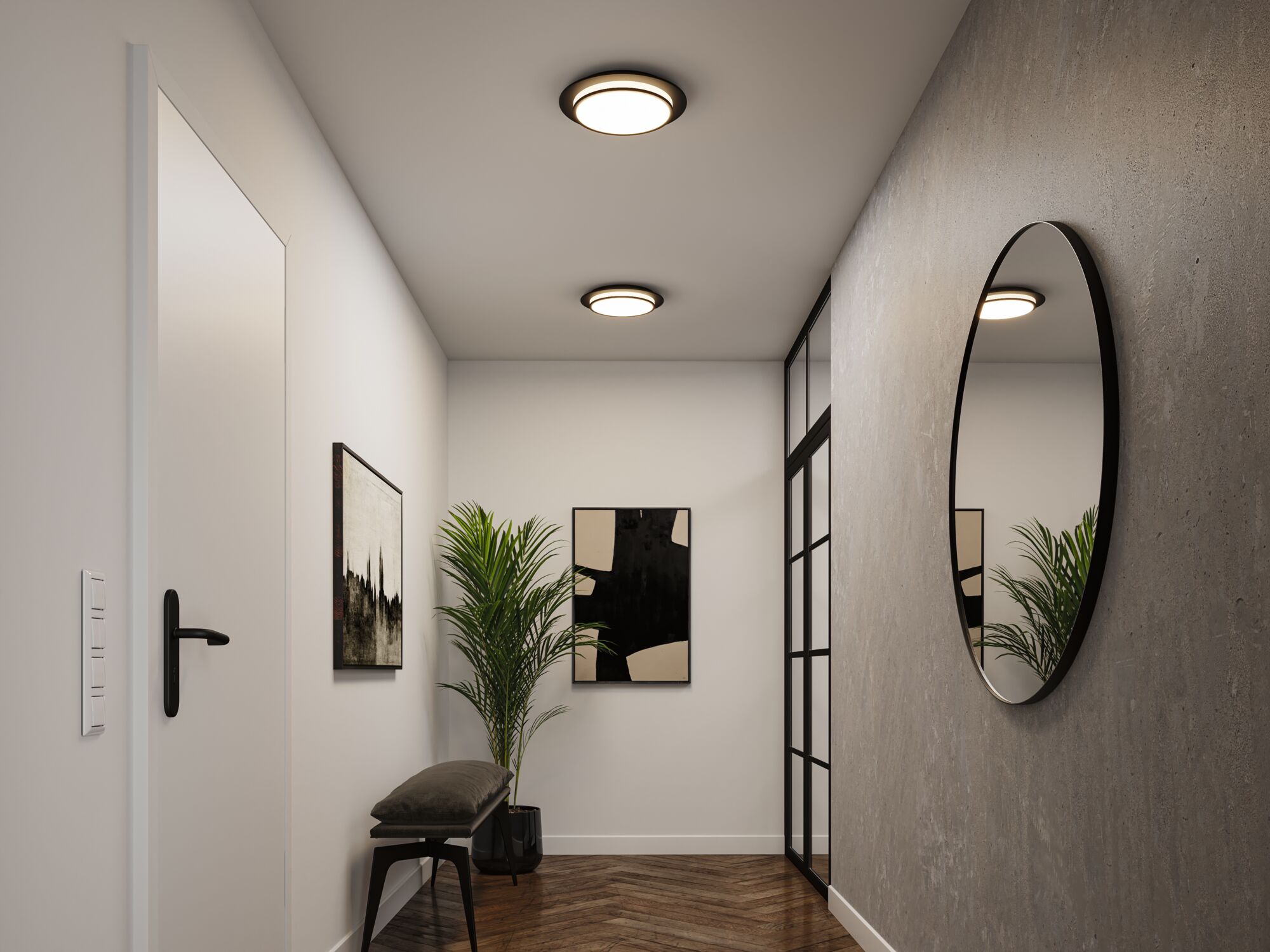 Modern hallway with round wall mirror and two black and white ceiling lights, wooden floor