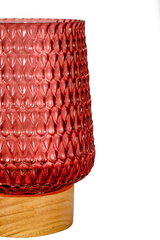 Red textured glass lamp on light wooden base, decorative lighting for living spaces