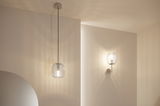 Modern pendant and wall light with clear glass and silver metal for ambient lighting in living spaces