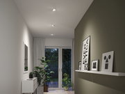 Modern hallway with white walls, green accent wall, plants, and minimalist Paulmann ceiling lights for home lighting.