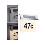Stainless steel solar house number light with illuminated white panel and black number 47c for outdoor use.