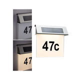 Stainless steel solar house number light with illuminated white panel and black number 47c for outdoor use.