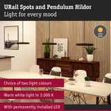 Modern black URail Spots Hildor pendant lights with warm white LED light above dining table in living room