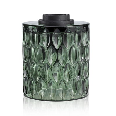 Green glass container with textured pattern and black lid, decorative home accessory