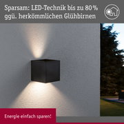 Schwarze LED-Wandleuchte aus Metall mit energiesparender Technik an grauer Außenwand