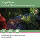 Projecteurs de jardin noirs avec lumière blanc chaud sur gravier et plantes pour éclairage extérieur chaleureux
