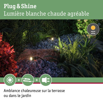 Projecteurs de jardin noirs avec lumière blanc chaud sur gravier et plantes pour éclairage extérieur chaleureux