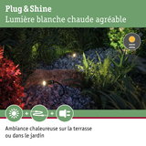 Projecteurs de jardin noirs avec lumière blanc chaud sur gravier et plantes pour éclairage extérieur chaleureux