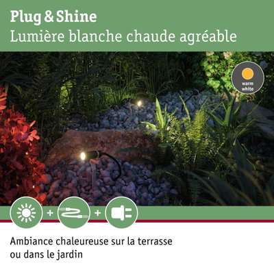 Projecteurs de jardin noirs avec lumière blanc chaud sur gravier et plantes pour éclairage extérieur chaleureux