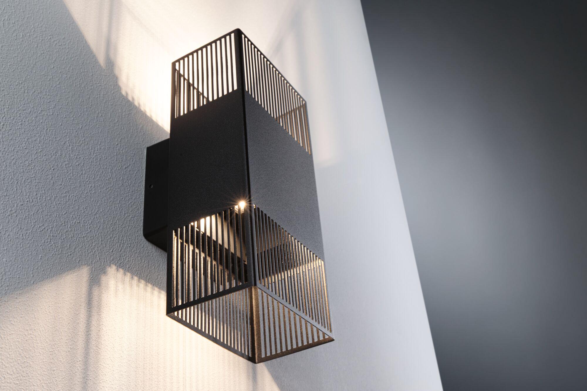 Modern black metal wall light with grid design and warm white light for indoor lighting