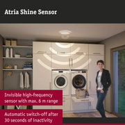 White ceiling light with Atria Shine sensor in modern laundry room with washing machine