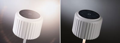 White solar garden spotlight with ribbed plastic housing and black solar panel for outdoor lighting