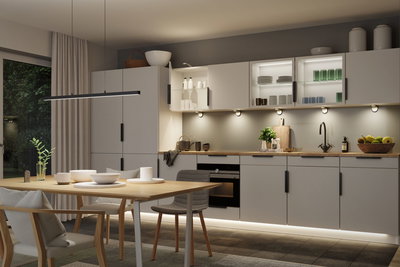 Moderne køkken med grå skabe, træbordplade og LED-underkabinetbelysning til stemningsfuldt lys