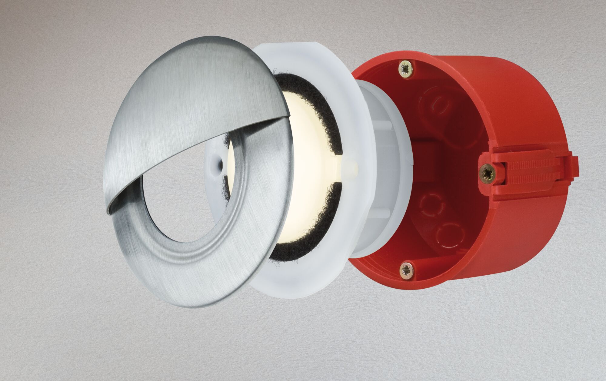 Exploded view of round LED recessed light with brushed stainless steel and red plastic housing.