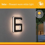 Solar-powered house number 6 with warm white light on grey wall for outdoor lighting