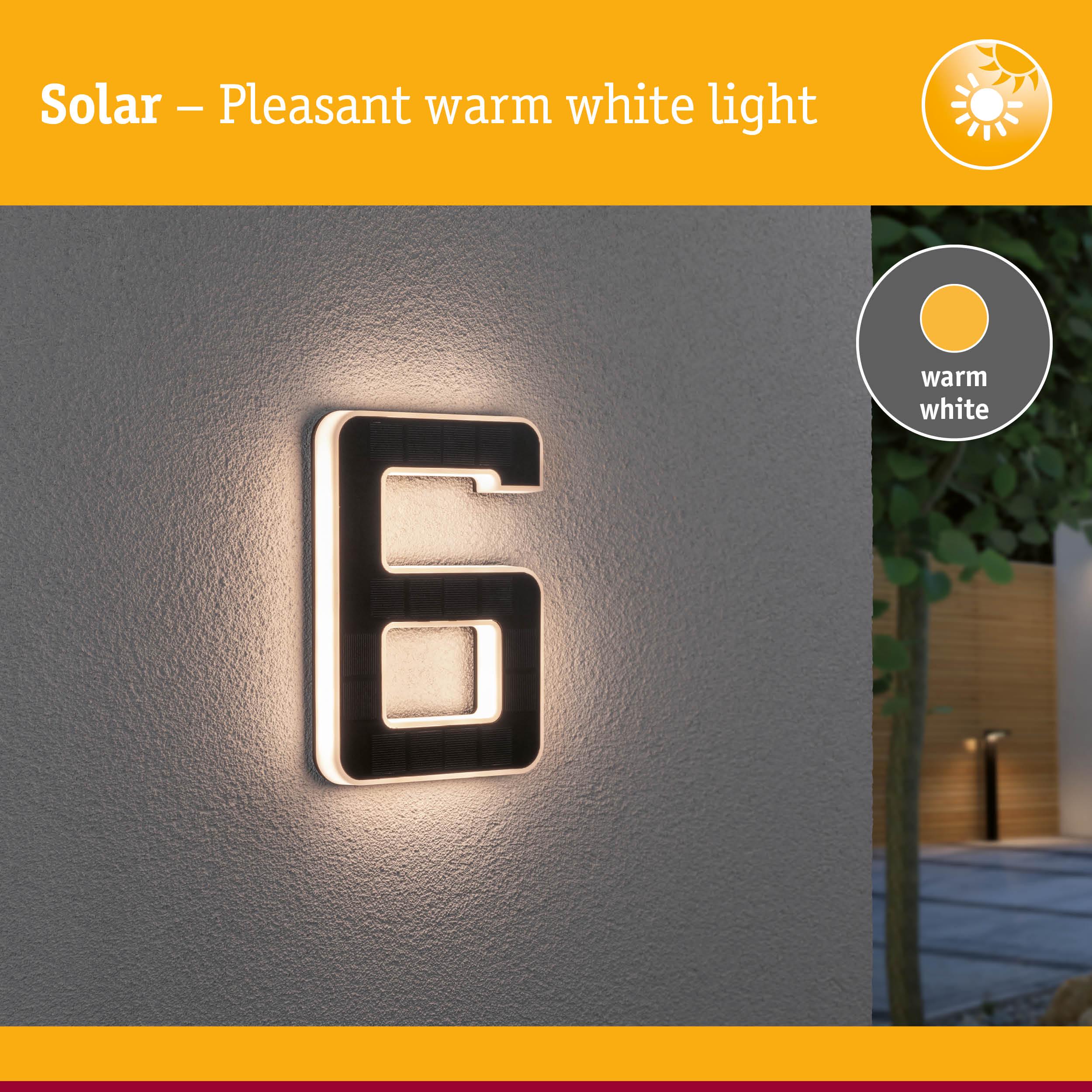 Solar-powered house number 6 with warm white light on grey wall for outdoor lighting