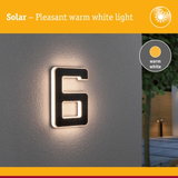 Solar-powered house number 6 with warm white light on grey wall for outdoor lighting