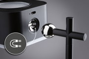 Black metal light with magnetic joint and shiny ball for adjustable lighting solutions.