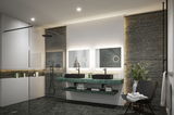 Modern bathroom with green marble countertop, black basins, and LED-lit mirrors for elegant lighting