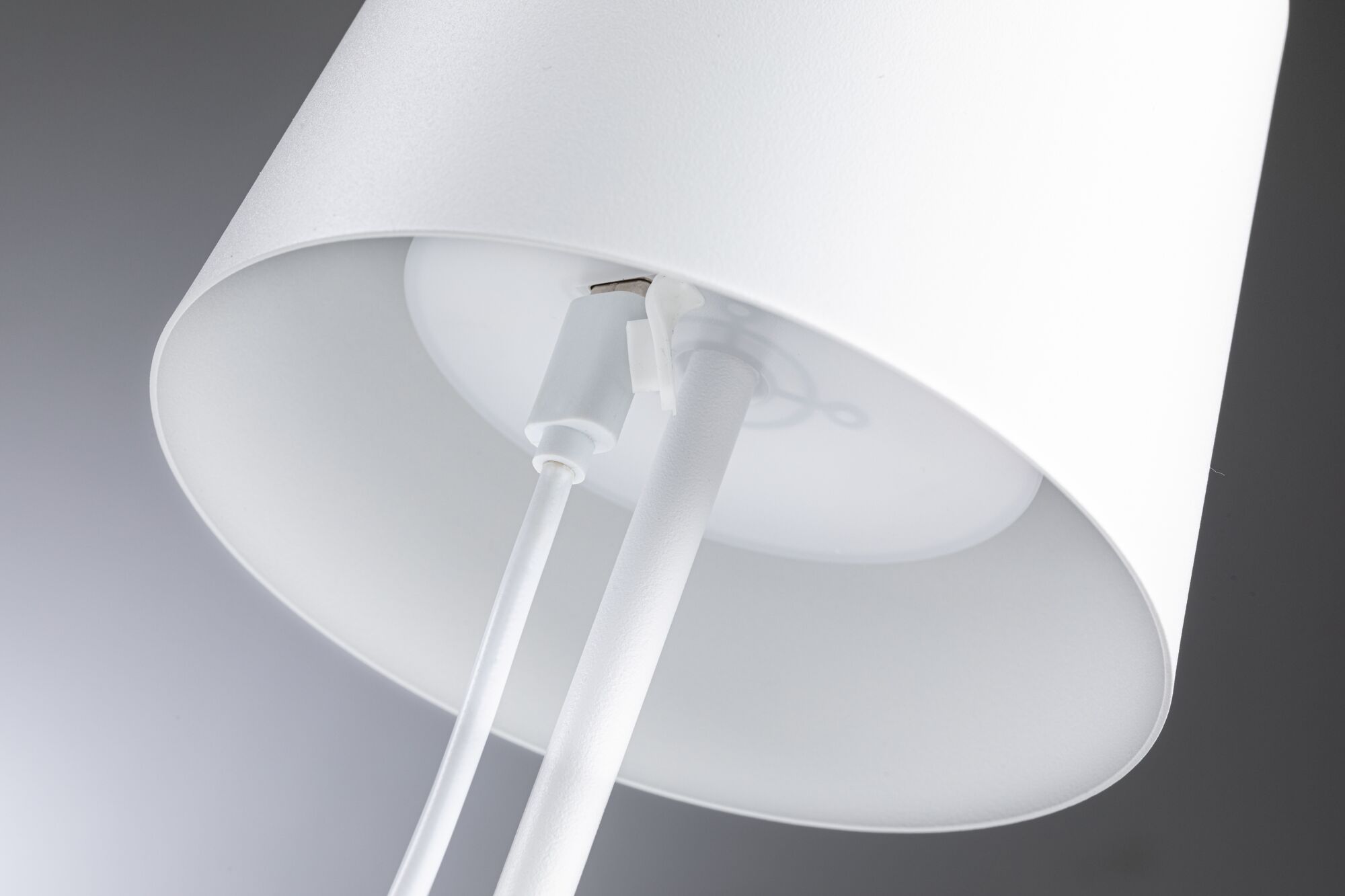 Close-up of white metal lampshade with cable and mount for LED lighting fixture