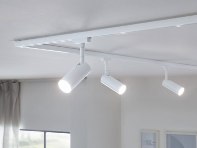 White metal LED track spotlights on ceiling for modern room lighting and accent illumination