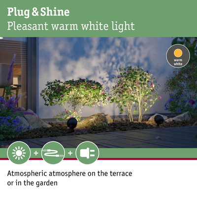 Warm white Plug & Shine LED garden light illuminating plants for atmospheric terrace lighting.