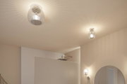 Two ceiling lights with clear ribbed glass and warm white light in a modern bathroom setting