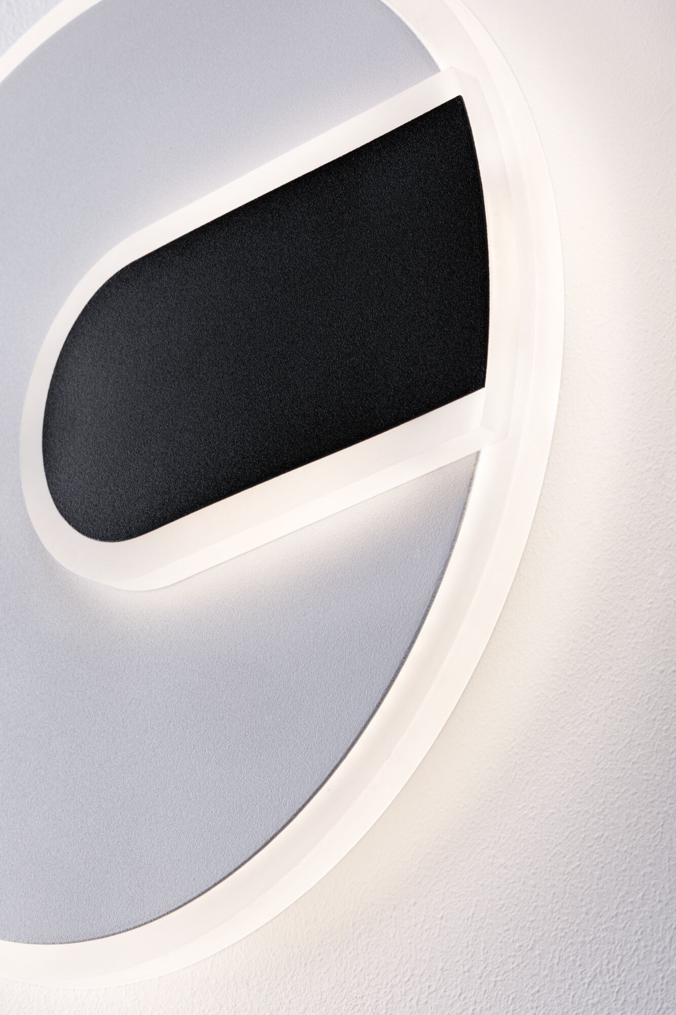 Modern round LED wall light in white with black accent for stylish indoor lighting