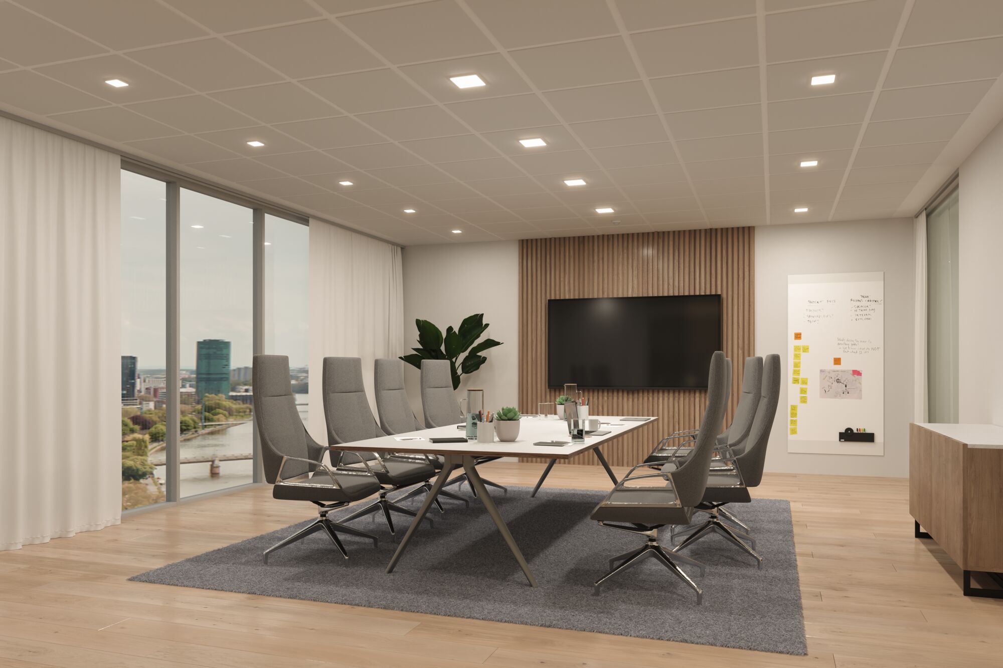 Modernes Büro mit grauen Bürostühlen und weißem Konferenztisch auf grauem Teppichboden